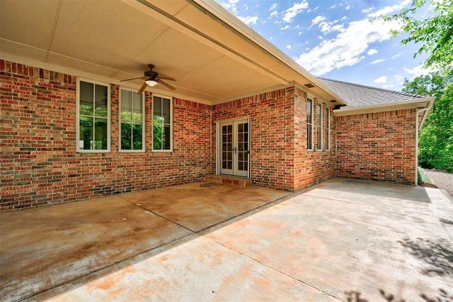 View of patio / terrace featuring a ceiling fan and french doors | Image 42