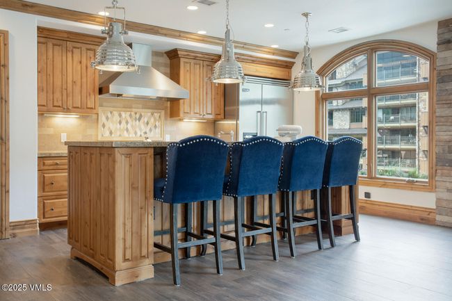This chef-inspired kitchen blends rustic elegance with modern performance—complete with Viking appliances, slab granite, and seating for four at the island. It’s both a design centerpiece and a gathering place. | Image 7