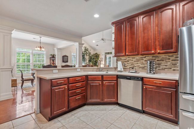 Kitchen with stainless steel appliances, light countertops, a peninsula, tasteful backsplash, and recessed lighting | Image 20