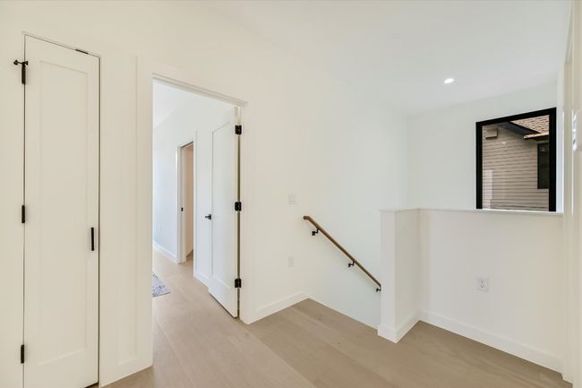 Hallway with an upstairs landing, light wood-style floors, and recessed lighting | Image 17