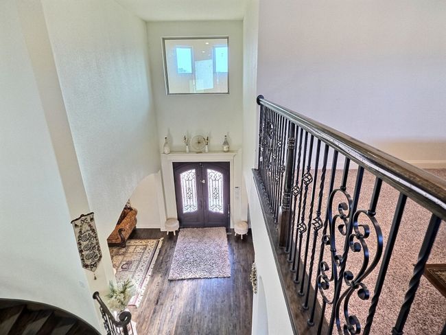 Foyer entrance with french doors, dark wood-type flooring, and a high ceiling | Image 17
