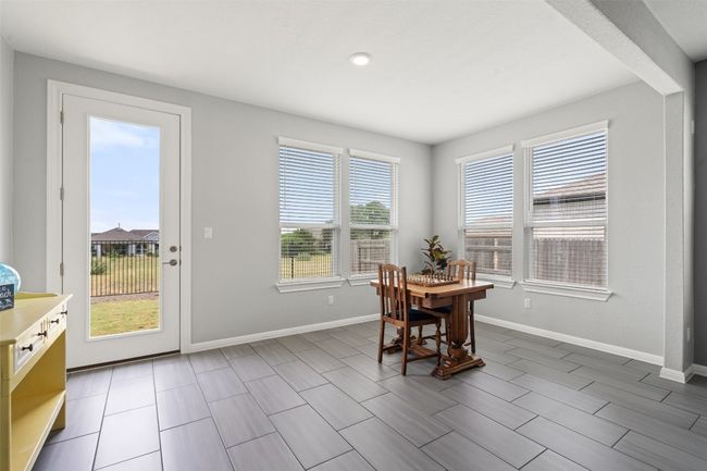 The sunroom-style bonus area off of the main living, overlooking the backyard. | Image 17
