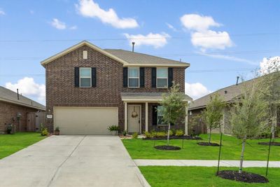 Welcome to 9719 Atwood Lake! This charming home greets you with a spacious double-wide driveway that leads up to a welcoming covered front porch. Enjoy the privacy of no neighbors directly in front of you and appreciate the classic appeal of a brick exterior on three sides of the house. | Image 1