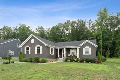 Ranch-style home with a front lawn and covered porch | Image 2