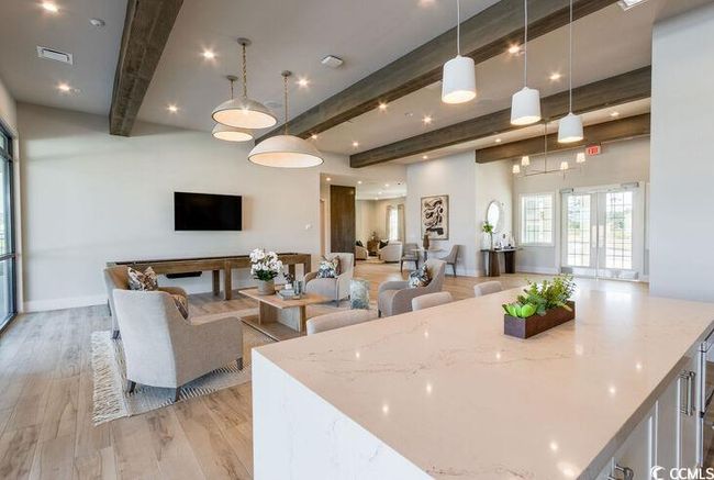 Kitchen with visible vents, beam ceiling, open floor plan, light wood-style floors, and light stone countertops | Image 24
