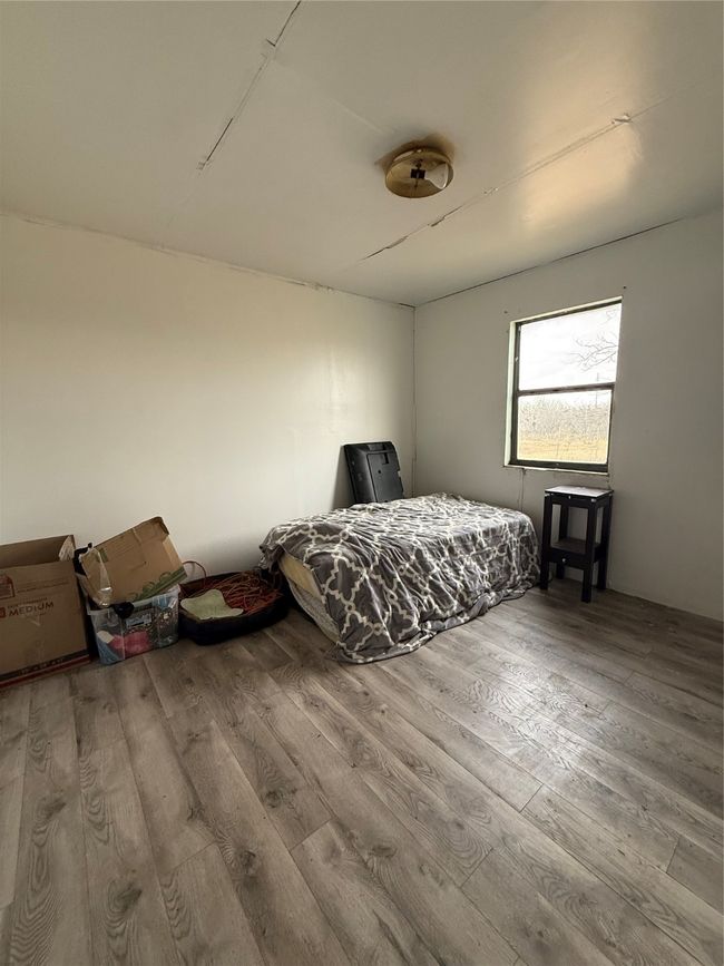 Bedroom with wood finished floors | Image 10