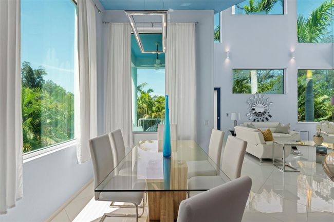 The designated dining area with bright natural light pouring in. | Image 12