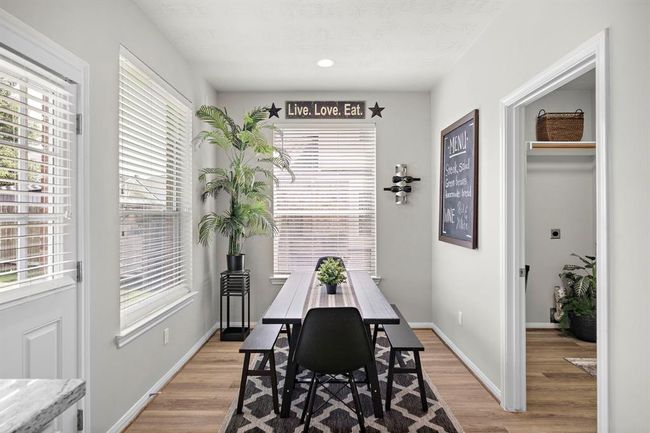 Breakfast room leading to utility room and garage on right. | Image 14