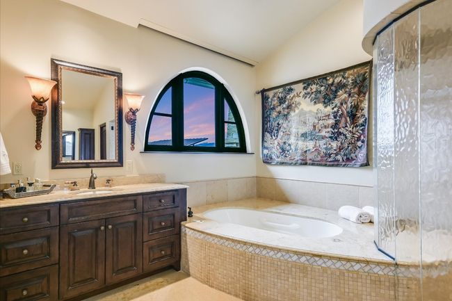 Full bathroom with tile patterned floors, lofted ceiling, vanity, and a garden tub | Image 30
