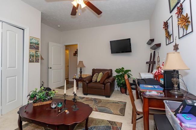 Living area featuring ceiling fan | Image 16