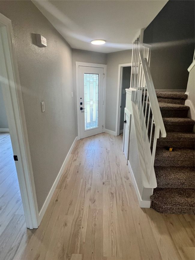 Doorway with light wood-type flooring and stairway | Image 15