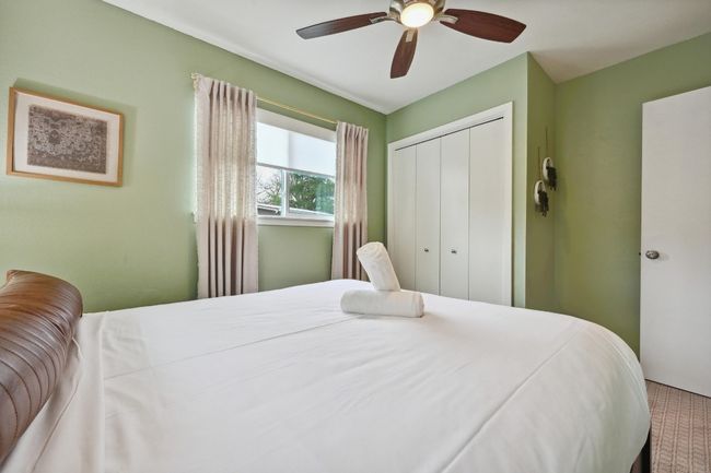 This vibrant bedroom comes with a refreshing color palate and closet storage. | Image 27