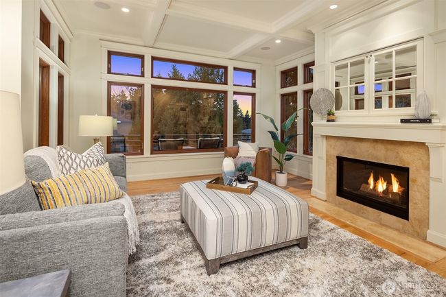Box beam ceilings, a substantial fireplace and elevated ceilings make this family room a favorite place to gather. | Image 14
