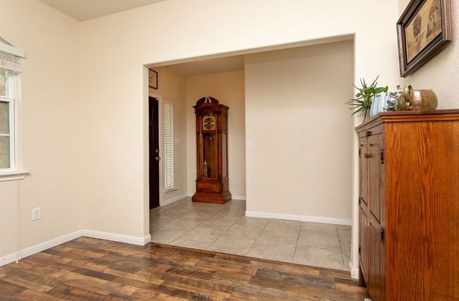 Empty room with wood finished floors and baseboards | Image 10