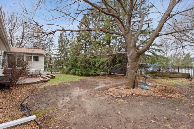 Spacious backyard with a large tree providing shade and privacy | Image 23