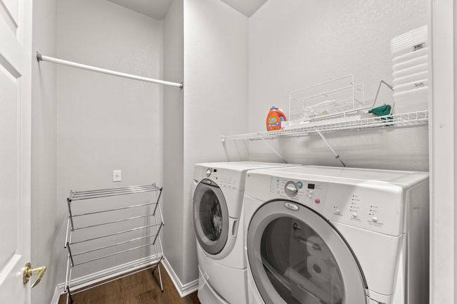 Washroom with independent washer and dryer, wood finished floors, and baseboards | Image 37