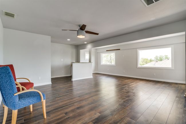 Second living area featuring a wet bar and lake views. | Image 11