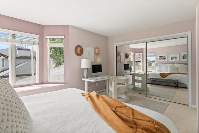 Carpeted bedroom featuring multiple windows and a closet | Image 22