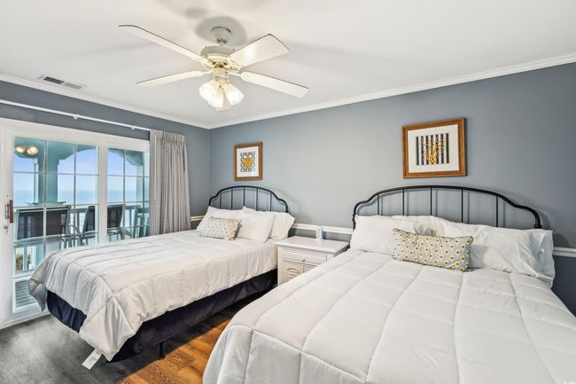 Bedroom with ornamental molding, access to outside, wood finished floors, and a ceiling fan | Image 30