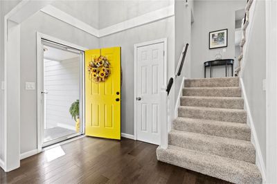 Entryway featuring a towering ceiling and dark wood-type flooring | Image 1