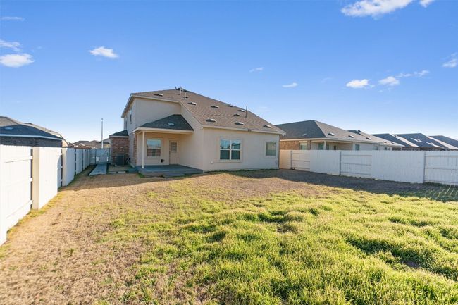 Back of house with a yard, a patio area, a fenced backyard, and stucco siding | Image 36