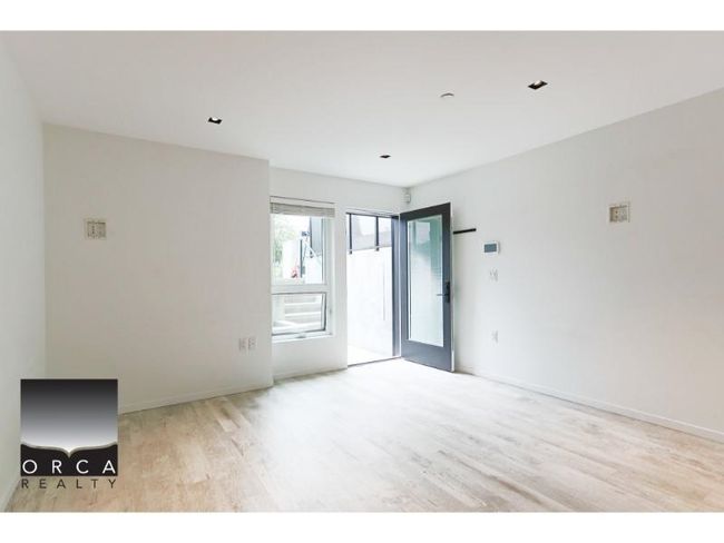 Spare room with wood finished floors and baseboards | Image 6
