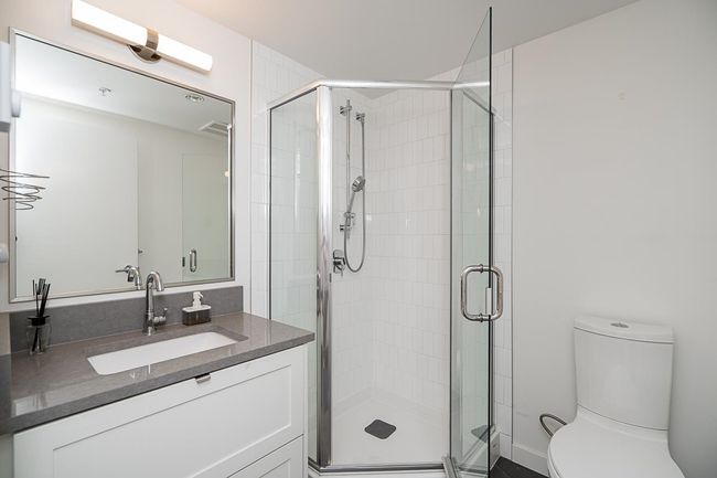 Bathroom featuring visible vents, a stall shower, vanity, and toilet | Image 27