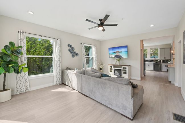 Living area featuring baseboards, light wood-style flooring, ceiling fan, and recessed lighting | Image 7