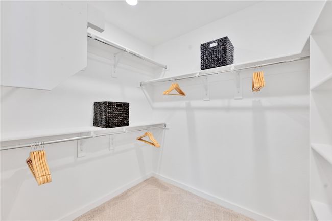 Spacious closet featuring light colored carpet | Image 20