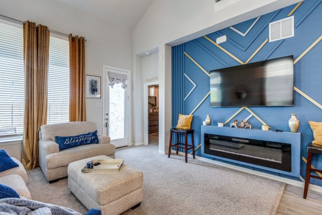 Living room featuring lofted ceiling, healthy amount of natural light, and baseboards | Image 10