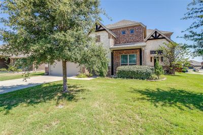 View of front facade featuring a front lawn and a garage | Image 2