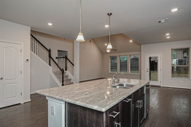 Kitchen featuring a sink, visible vents, dark wood-type flooring, and a ceiling fan | Image 13