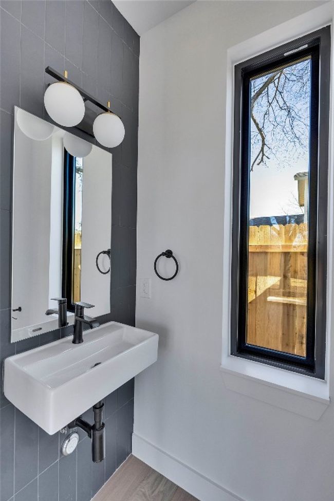 Bathroom featuring a sink, baseboards, and wood finished floors | Image 24