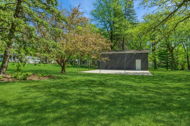 The extra shed is 14x36. It is perfect for your camper or RV and it includes 30 amp and 50 amp services. The shed also has concrete floor and built in storage. 32x32 concrete pad has built in basketball hoop and netting to catch those hockey pucks! | Image 49