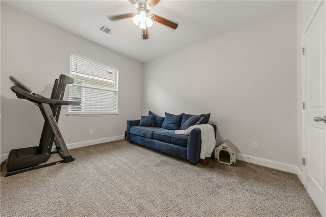 Exercise room with carpet and a ceiling fan | Image 13