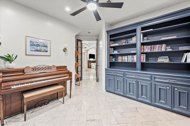 Just off the entry, the study offers rich built-ins, deep blue cabinetry, and a quiet space to work or create, with serene views out front. | Image 8