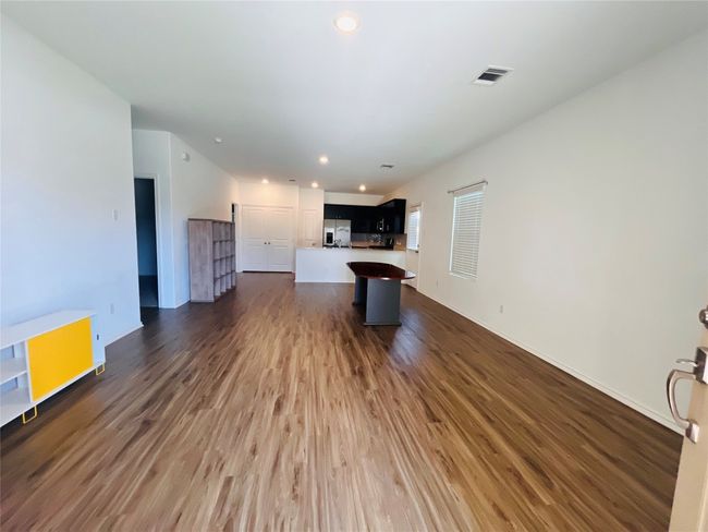 Unfurnished living room featuring dark wood-style floors and recessed lighting | Image 5