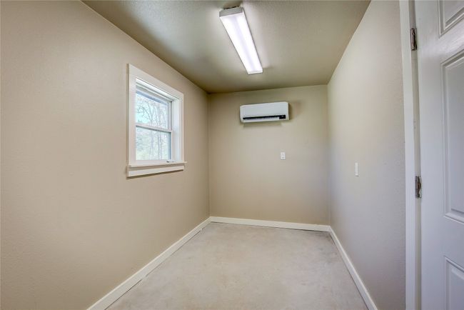 Unfurnished room with a wall mounted AC and baseboards | Image 14
