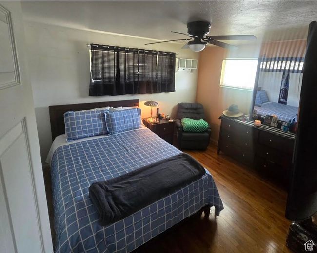 Bedroom with visible vents, a ceiling fan, and wood finished floors | Image 12