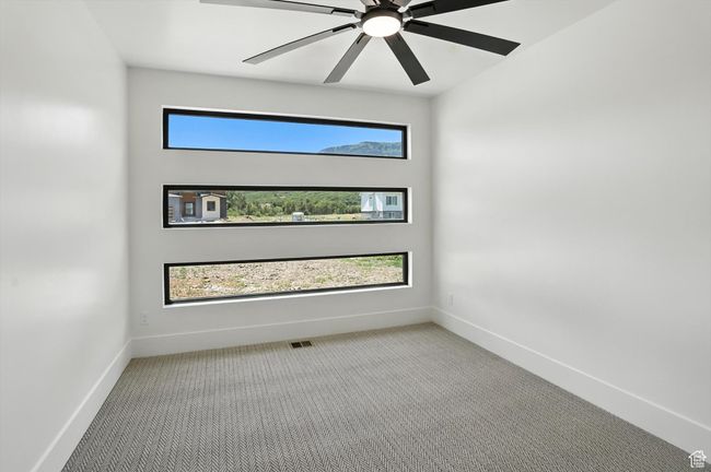 Carpeted spare room with baseboards and a ceiling fan | Image 22