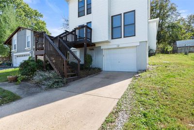 Townhome / multi-family property with a garage and a front yard | Image 2