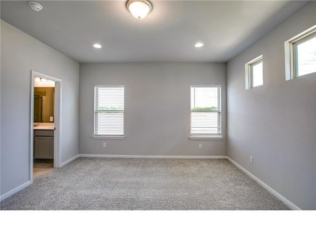 Spare room with light colored carpet, a smoke detector, and recessed lighting | Image 12