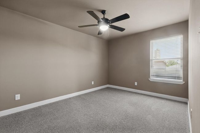 Empty room with ceiling fan, carpet, and baseboards | Image 23