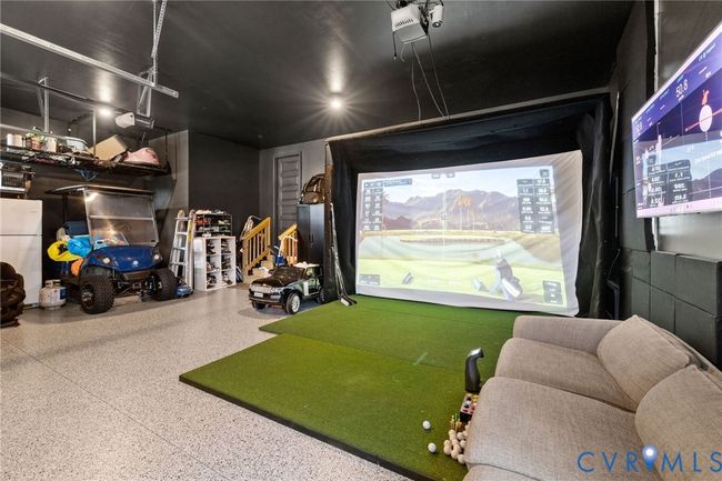 Rec room featuring golf simulator and speckled floor | Image 39