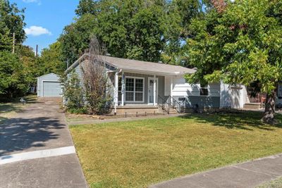 View of front of home with a front yard, an outbuilding, and a garage | Image 2