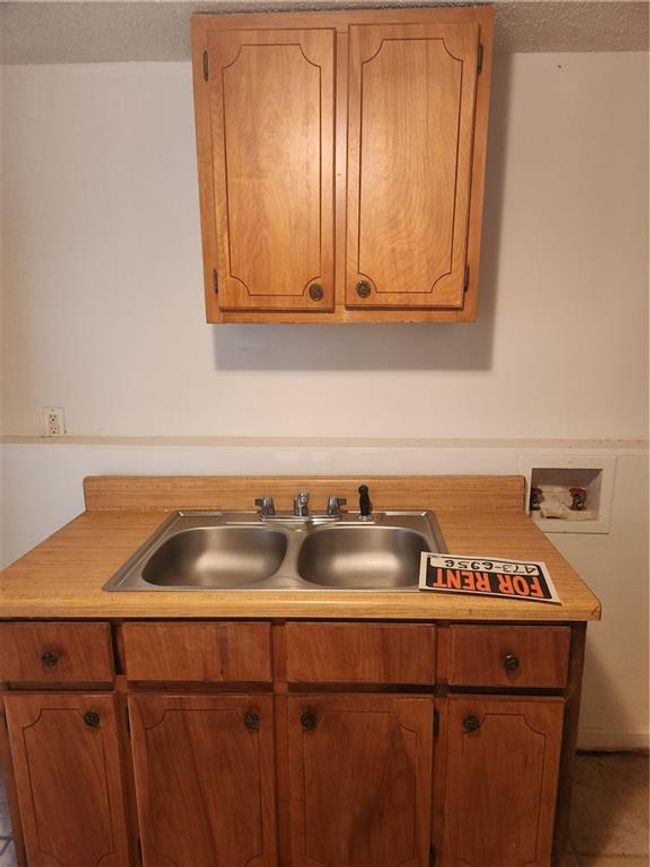 Kitchen with sink, tile patterned floors, and a textured ceiling | Image 10