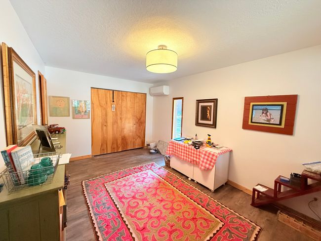 Bonus room with wood finished floors, an AC wall unit, and a textured ceiling | Image 25