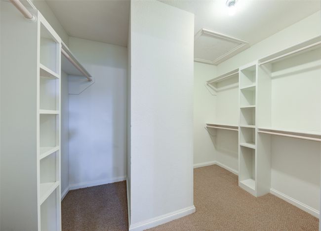 Spacious closet featuring carpet flooring and attic access | Image 24