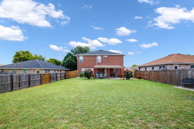 Back of property with a patio area, a fenced backyard, and brick siding | Image 20