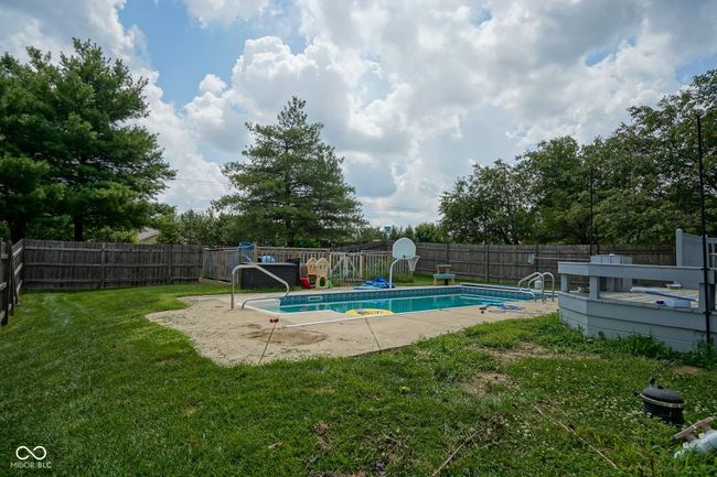 view of swimming pool featuring a fenced backyard and a deck | Image 40